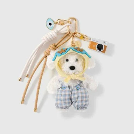 Adorable teddy bear keychain in plaid overalls with camera and evil eye charms, perfect for handbags or daily accessories.